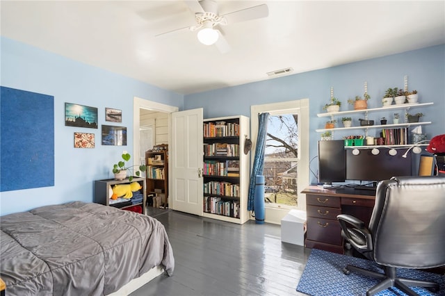 bedroom featuring visible vents, a ceiling fan, and hardwood / wood-style floors