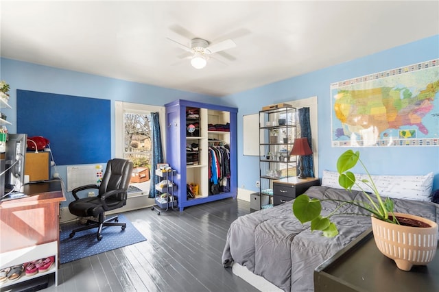 bedroom with a closet, a ceiling fan, and wood finished floors