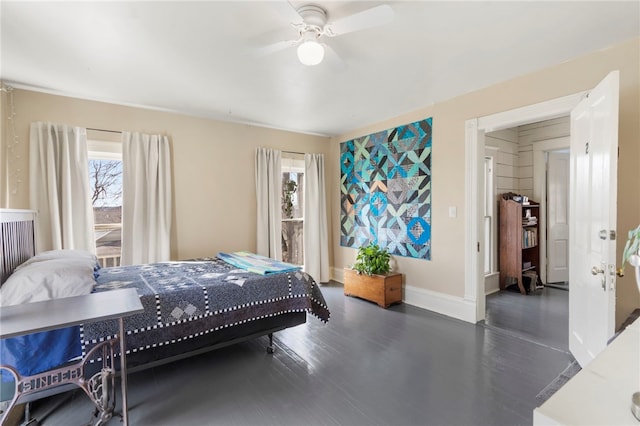 bedroom featuring a ceiling fan, wood finished floors, and baseboards