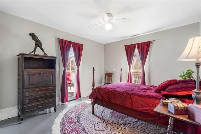 bedroom featuring access to exterior, finished concrete floors, a ceiling fan, and visible vents