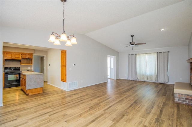 unfurnished living room featuring vaulted ceiling, ceiling fan with notable chandelier, visible vents, and light wood finished floors