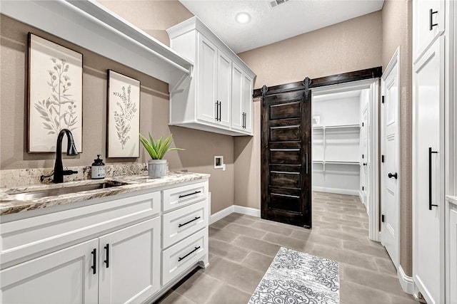 full bath with visible vents, baseboards, vanity, tile patterned floors, and a textured ceiling