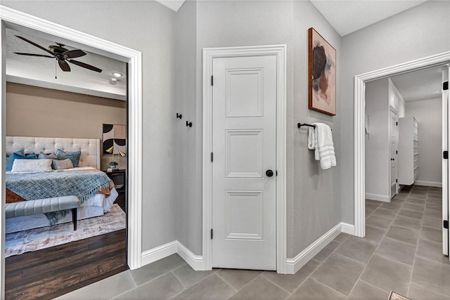 hall featuring baseboards and tile patterned flooring