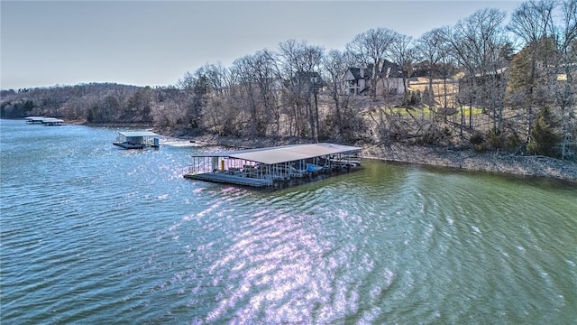 view of dock featuring a forest view and a water view