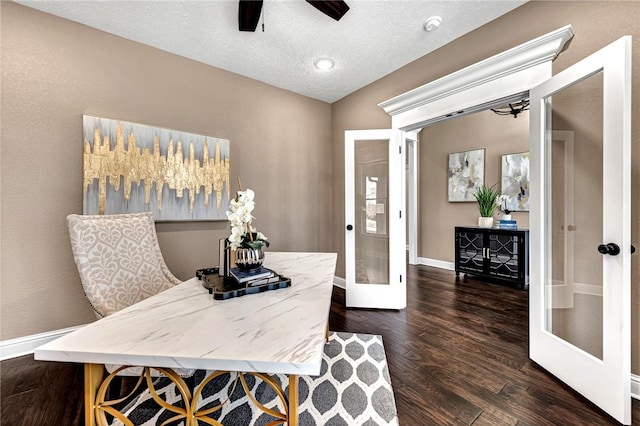 office with a ceiling fan, baseboards, dark wood-type flooring, french doors, and a textured ceiling