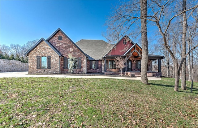 view of front facade with brick siding, board and batten siding, and a front lawn