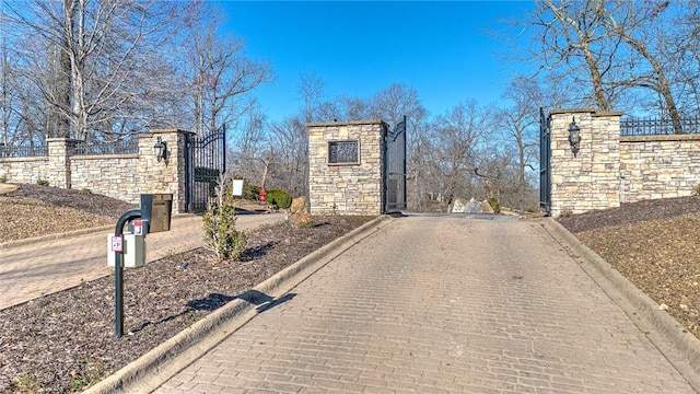 view of street with curbs and a gate