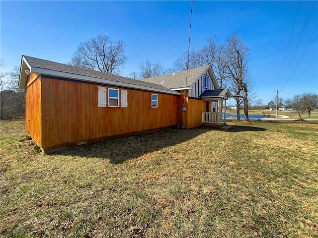 view of side of property with crawl space and a yard