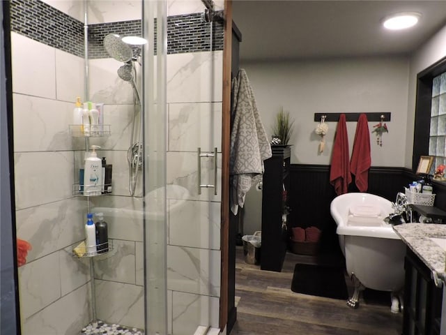 1820 Oak Grove Rd, Van Buren, AR 72956 - full bathroom featuring a shower stall, wood finished floors, wainscoting, a freestanding tub, and vanity