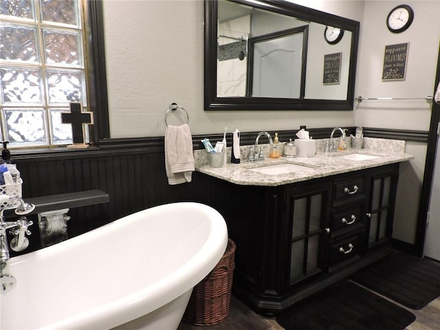 1820 Oak Grove Rd, Van Buren, AR 72956 - bathroom featuring double vanity, a soaking tub, a wainscoted wall, and a sink