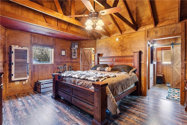 bedroom featuring visible vents, hardwood / wood-style floors, a barn door, wood walls, and wood ceiling