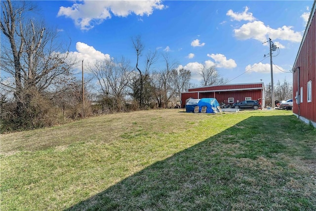 view of yard featuring an outbuilding and a pole building