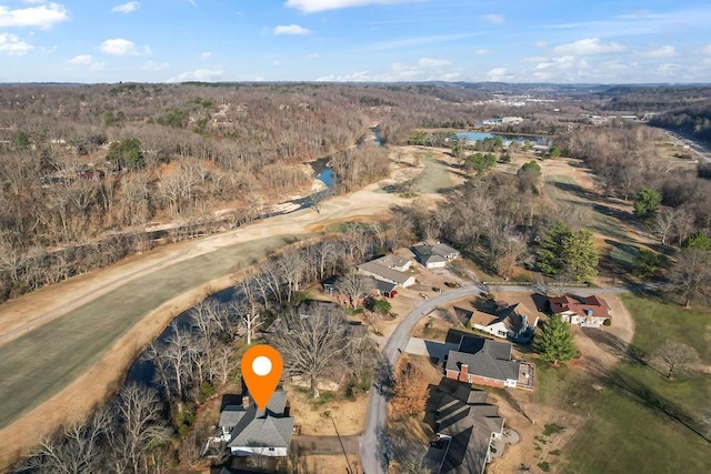 bird's eye view featuring a forest view and a water view