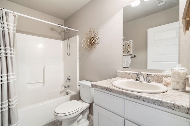 bathroom with visible vents, shower / bath combo with shower curtain, toilet, a textured wall, and vanity