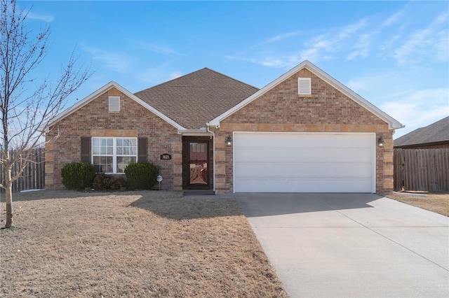 ranch-style house with driveway, fence, a shingled roof, a garage, and brick siding