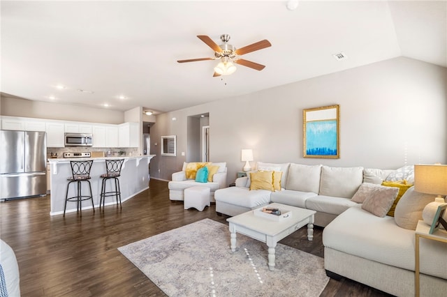 living room featuring a ceiling fan, visible vents, recessed lighting, dark wood-style flooring, and vaulted ceiling