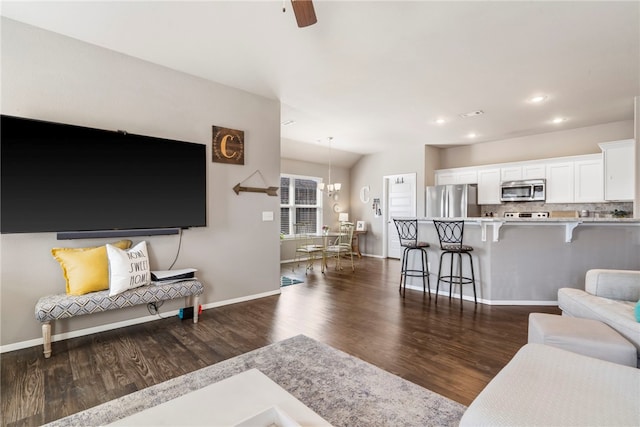 living area featuring dark wood-style floors, a chandelier, recessed lighting, and baseboards