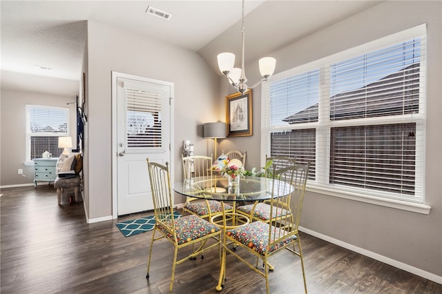 dining space featuring visible vents, baseboards, an inviting chandelier, and wood finished floors