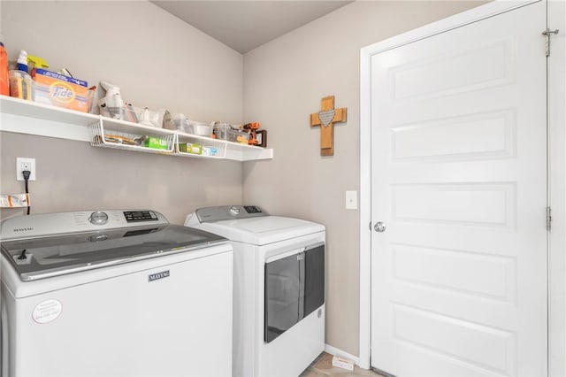 laundry area featuring baseboards, independent washer and dryer, and laundry area