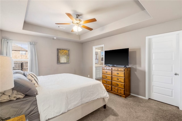 bedroom with visible vents, a raised ceiling, light colored carpet, and baseboards