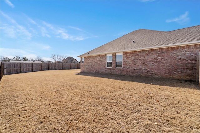 view of yard with a fenced backyard