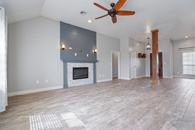 unfurnished living room featuring vaulted ceiling, baseboards, visible vents, a ceiling fan, and a large fireplace