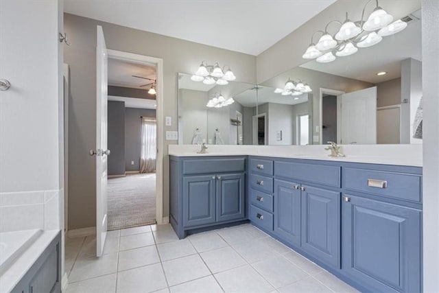 bathroom featuring ceiling fan, tile patterned floors, double vanity, and a sink
