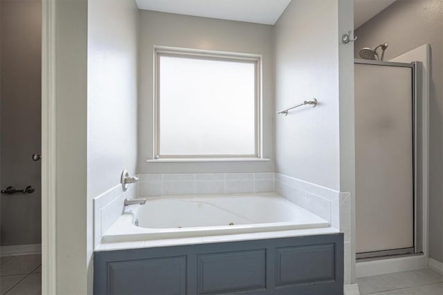 full bath with tile patterned flooring, a shower stall, and a jetted tub