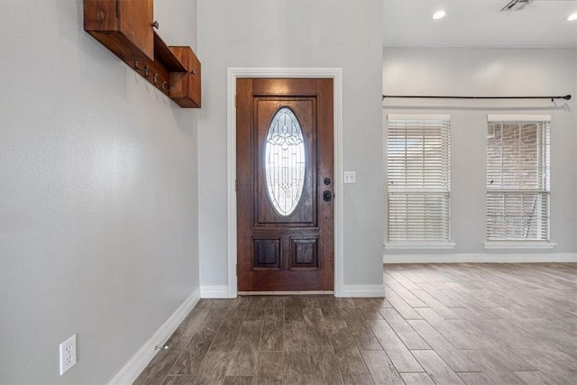 entrance foyer with dark wood-type flooring, recessed lighting, and baseboards