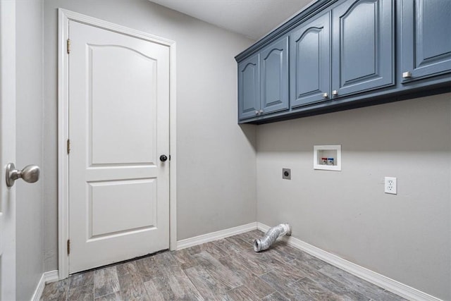 laundry area featuring wood finished floors, baseboards, cabinet space, electric dryer hookup, and washer hookup