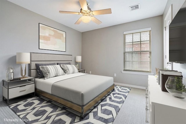 carpeted bedroom featuring visible vents, a ceiling fan, and baseboards