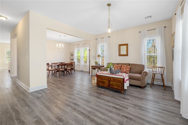 living area featuring wood finished floors, visible vents, and baseboards