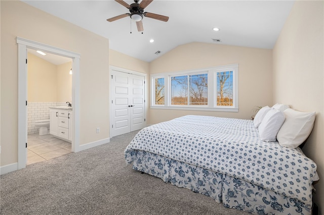 bedroom with a sink, visible vents, light carpet, and lofted ceiling