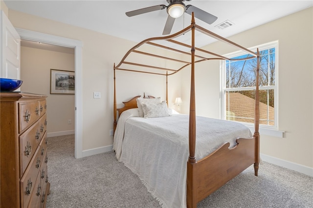 bedroom featuring visible vents, baseboards, light colored carpet, and a ceiling fan