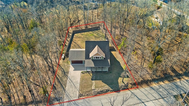 drone / aerial view featuring a forest view