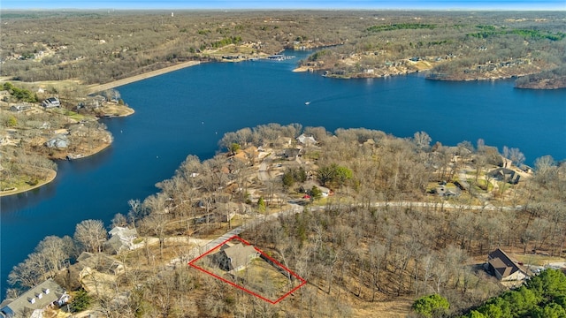 aerial view with a forest view and a water view