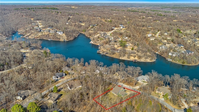 aerial view featuring a wooded view and a water view