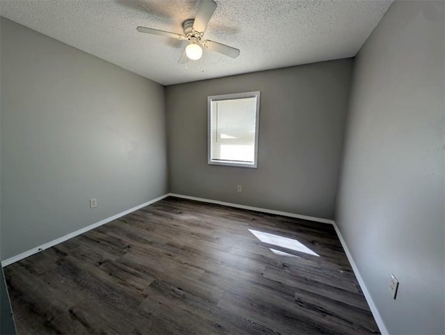 unfurnished room featuring a ceiling fan, wood finished floors, baseboards, and a textured ceiling