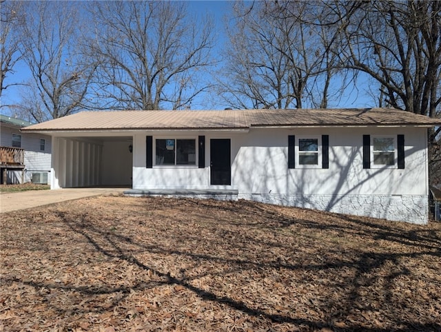 ranch-style house with a carport and driveway