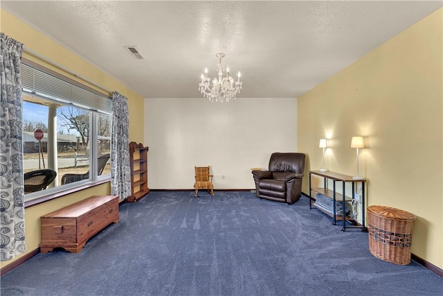 sitting room with visible vents, baseboards, a chandelier, carpet floors, and a textured ceiling