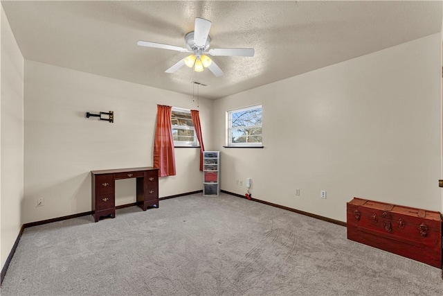 unfurnished bedroom featuring visible vents, a textured ceiling, baseboards, and carpet