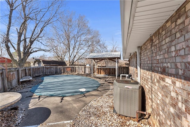 view of patio featuring a fenced backyard and central AC