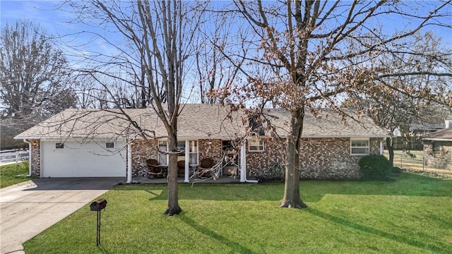 ranch-style house featuring a garage, a front yard, concrete driveway, and brick siding