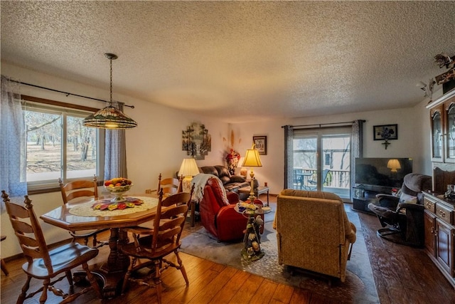 dining area featuring a textured ceiling and hardwood / wood-style flooring