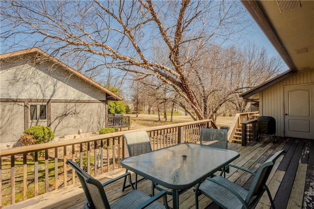 deck with outdoor dining area