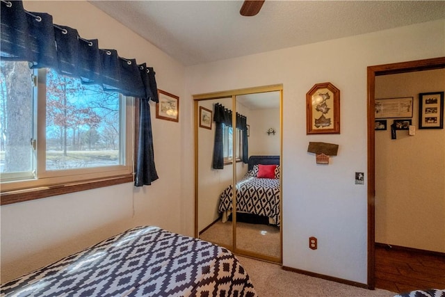 bedroom with carpet, baseboards, a closet, and a ceiling fan