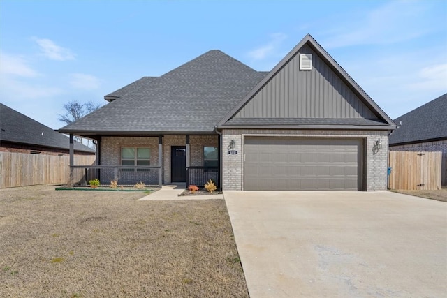 view of front facade featuring fence, driveway, a porch, an attached garage, and brick siding