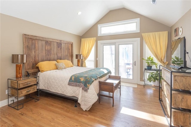 bedroom featuring access to exterior, light wood-style floors, baseboards, and high vaulted ceiling