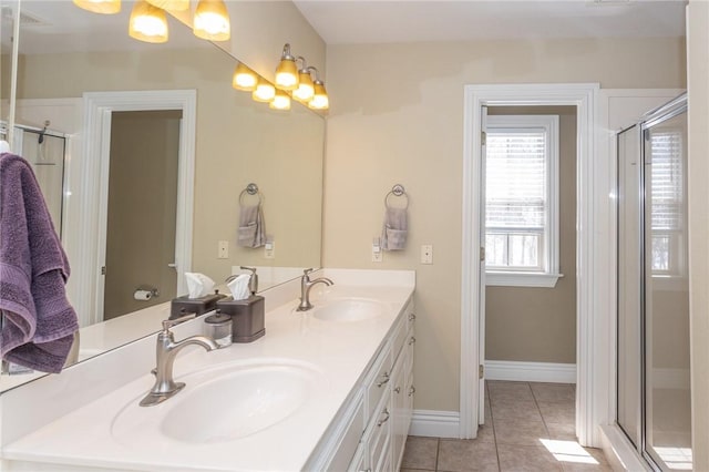 bathroom with a sink, a shower stall, and tile patterned floors