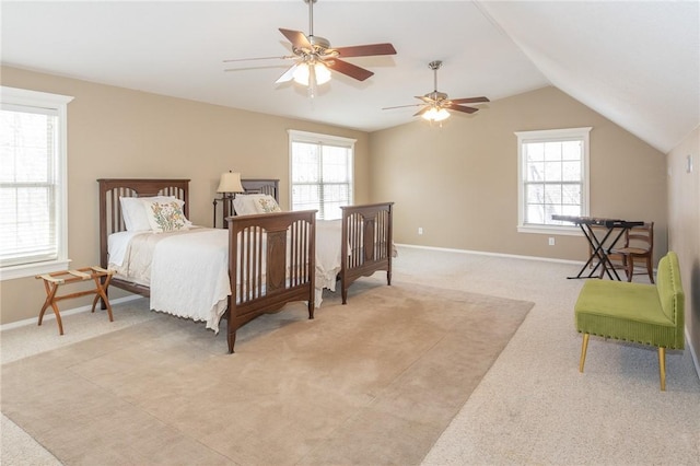 bedroom featuring light carpet, ceiling fan, baseboards, and lofted ceiling